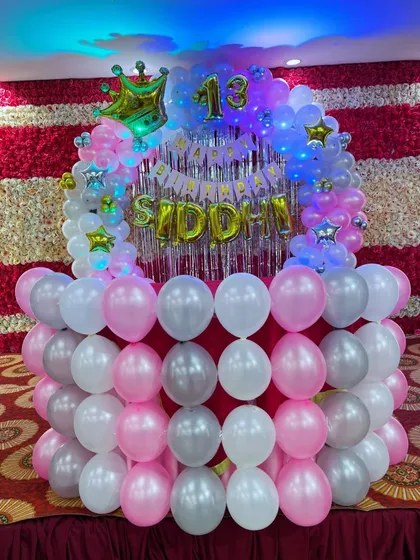The 13th birthday stage decoration with LED lights turned on, creating a vibrant look.
