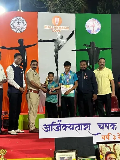A young athlete receiving his medal at the Mallakhamb competition.