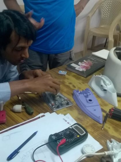 A participant uses a multimeter to diagnose a problem with a small appliance. We provide the necessary tools and a safe space to learn about electrical circuits and home appliance repair.