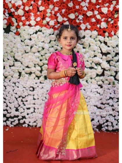 Another one of my little clients shining in a traditional half saree. The bright yellow and pink combination is perfect for festive celebrations, making her look like a little princess.