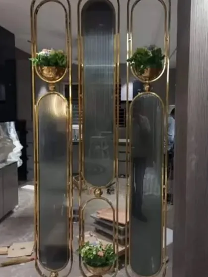Another example of a custom metal and glass partition. This one incorporates built-in planters, blending functionality with biophilic design to bring a touch of nature indoors.