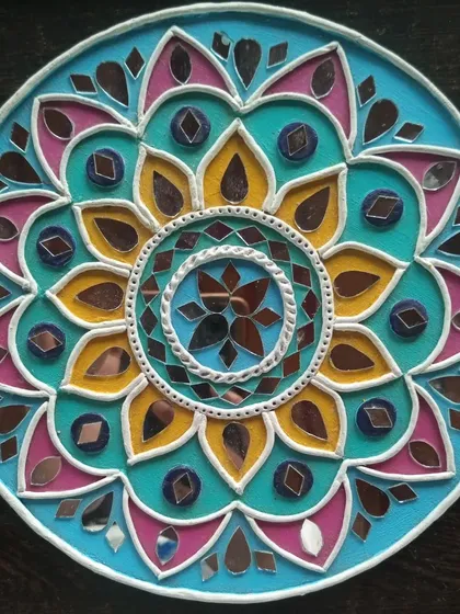 A finished Lippan art piece, showcasing the vibrant colors and intricate mirror work that make this traditional craft so special. In my workshop, you'll learn to create your own beautiful mandala-style design.
