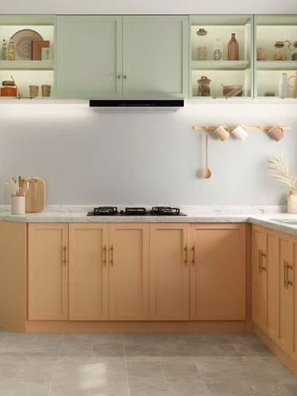 A cheerful and modern kitchen design with two-toned cabinets in soft green and light wood. This L-shaped layout is perfect for smaller spaces, offering ample storage and a bright, airy feel.