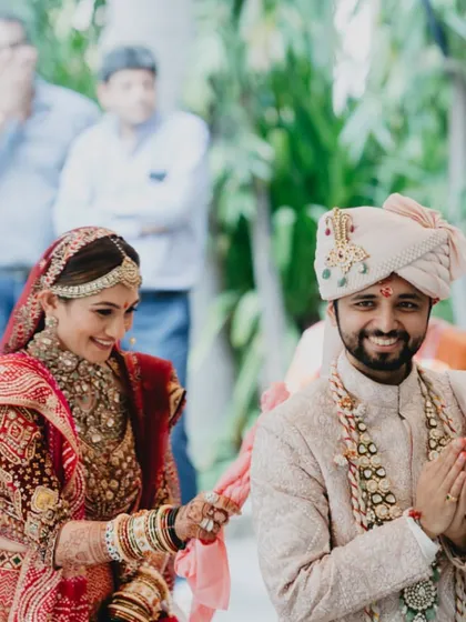 A candid shot of the couple sharing a laugh during their temple wedding ceremony.
