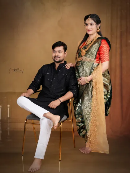 A candid moment of connection between a couple during their traditional maternity shoot. The intricate details of the Maharashtrian-style saree and the loving gaze between them make this a cherished memory.