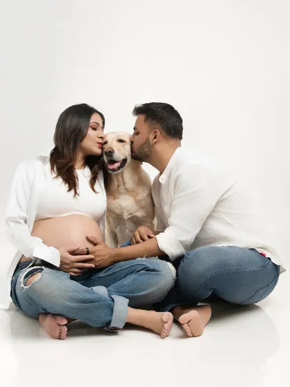 Your family story includes every member, even the furry ones. I love creating family-inclusive maternity sessions where your pets can join in the celebration. This portrait captures the complete love and excitement of a family of three about to become four.