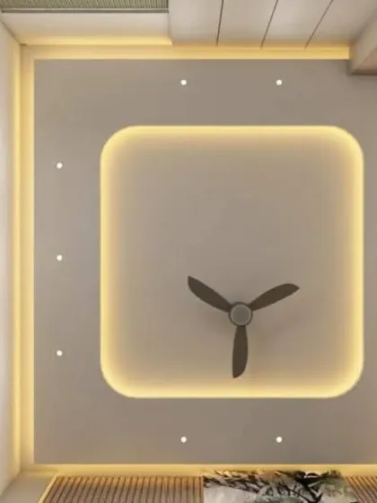 A cozy and modern bedroom ceiling design. The central feature is a simple square with rounded corners and cove lighting, complemented by spotlights for a bright and airy atmosphere.