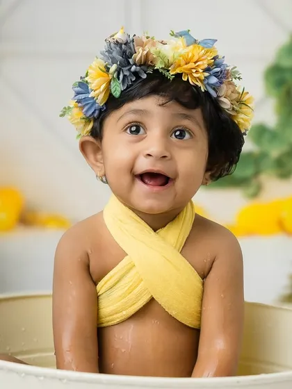 A bright, joyful smile that lights up the entire studio. This is what celebrating a first birthday is all about.
