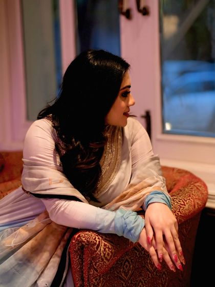 A candid profile shot of the model looking out a window, lost in thought. A beautiful, story-driven portrait.