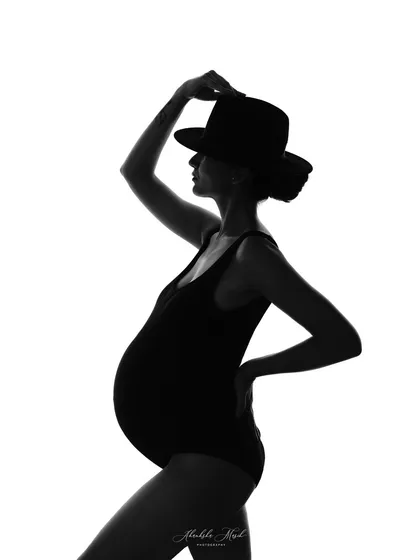 The silhouette is a powerful way to celebrate the beautiful form of motherhood. This fine art style focuses on shape and emotion, creating a dramatic and timeless portrait that is pure art.
