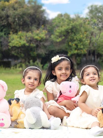 A fun outdoor session with three sisters. I love capturing the natural light and genuine interactions of children playing together in a park setting.