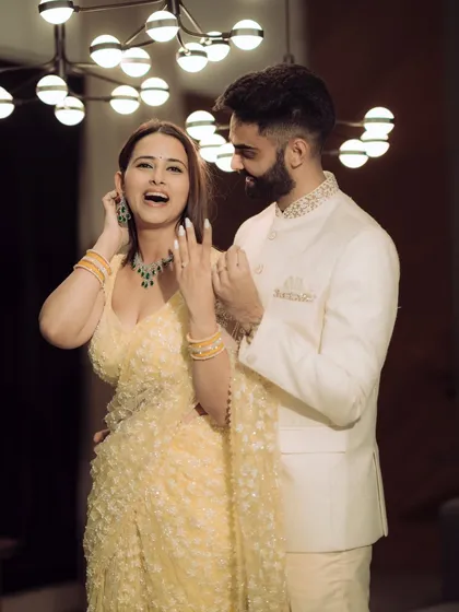 A joyful and candid shot from a Mumbai engagement shoot. The modern lighting and the couple's laughter create a vibrant and energetic image that perfectly captures the celebratory mood.