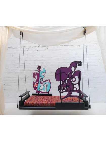 The swing configured with the backrests in an asymmetrical arrangement, encouraging different seating positions and interactions. The design challenges the conventional idea of a swing.