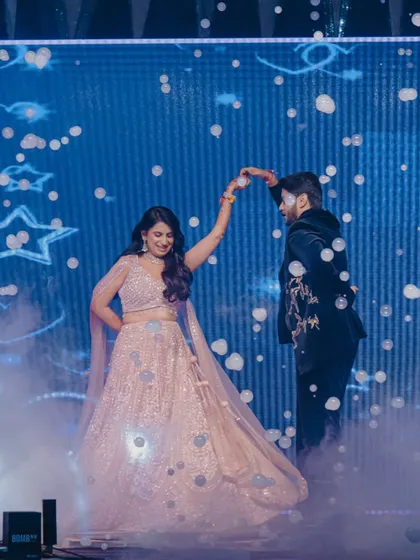 A fairytale first dance. I used a bubble machine and a dreamy blue LED backdrop with star motifs to create this magical moment, making the couple feel like they were dancing in the clouds.