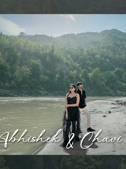 Standing strong together against the vastness of the river and mountains. This wide shot captures the epic scale of the landscape, making the couple's portrait feel both grand and timeless.