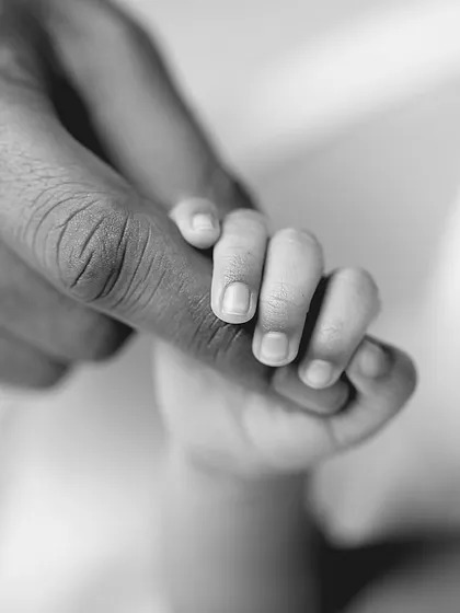 Sometimes, the tiniest details tell the biggest story. A newborn's hand instinctively curling around a parent's finger is a powerful symbol of trust, safety, and the beginning of an unbreakable bond.