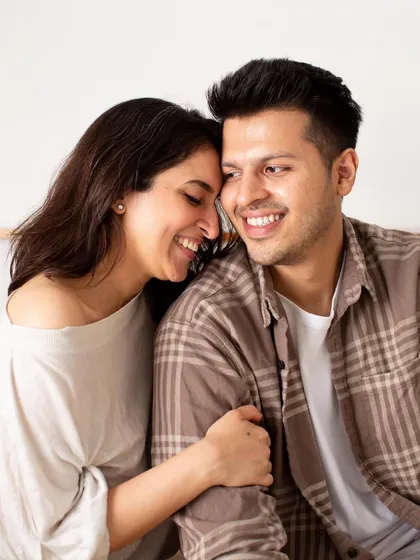 An in-home couple session allows for a special kind of intimacy and comfort. The soft smiles and gentle touch in this photo reflect the warmth and ease of being in your own space, creating authentic and heartfelt portraits.