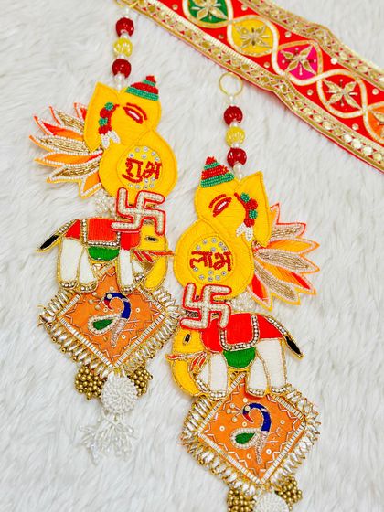 A playful and colorful Shubh Labh set with elephant motifs. The bright yellow and orange design is perfect for adding a cheerful touch to your Diwali decor.