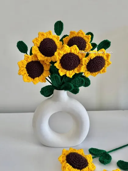 These are my handmade crochet sunflowers, which I call 'forever flowers' because they never wilt. This bouquet shows how bright and cheerful they are, perfect for adding a pop of color to your home without needing any water or sunlight. They make a lovely, lasting gift.