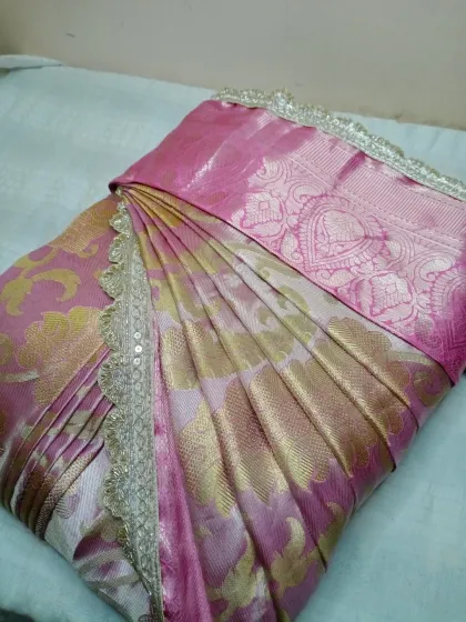 A beautiful pink and gold Banarasi saree, pleated and ready for a housewarming ceremony. My service is perfect for any festive occasion.