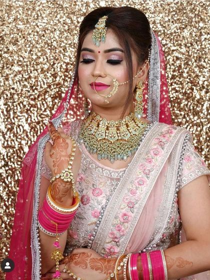 This bride chose a soft pink floral lehenga for her special day. The mint-green beaded jewellery from our rental collection adds a fresh and contemporary feel.