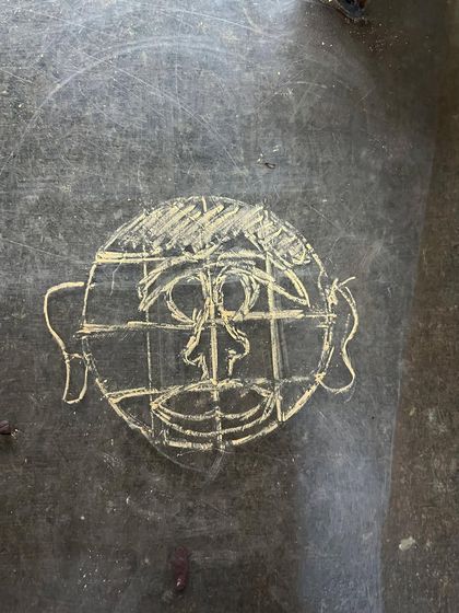 Learning to sculpt a face starts with understanding the basic structure. This simple sketch, done during an anatomy class, shows the foundational grid we use to place the features. Practice begins with observation.