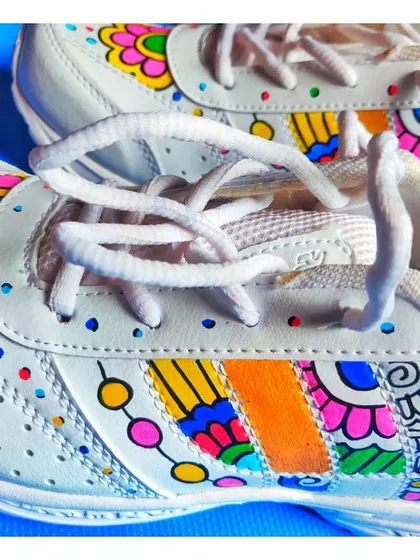 A close-up shot focusing on the laces and the detailed patterns along the side, showing how the design integrates with the shoe's structure.