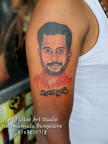 This is the kind of work I love to do. A realistic portrait tattoo to honor 'Appaji' (father), capturing his likeness on the upper arm. Creating these memorial tattoos is a privilege.