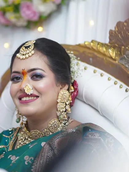 A close-up capturing the bride's happy expression. The subtle shimmer on the eyes adds a touch of glamour to the look.