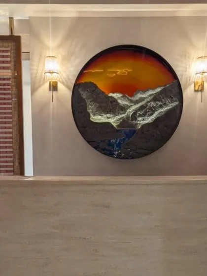 This piece, 'Land of Rising Sun,' was a special commission for Arunachal Bhavan in Delhi. It was a joy to bring the serene beauty of the mountains to life using rich textures and glowing resin, creating a focal point for this beautiful space.