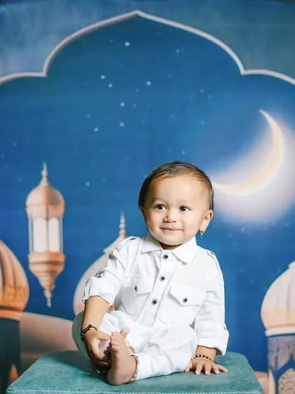 Eid Mubarak! This serene setup with a crescent moon and mosque backdrop is perfect for celebrating Eid with a memorable photoshoot.