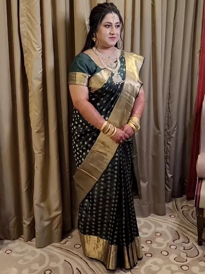 For her Dakshina Kodukkal ritual, bride Shruti chose a beautiful black Kanjeevaram with a wide gold border. My draping ensures the traditional look is both comfortable and graceful.
