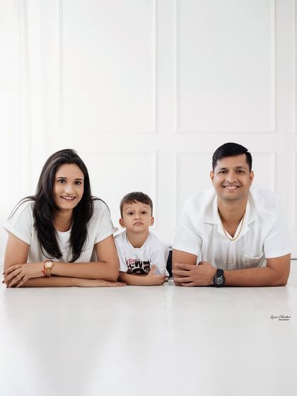 A unique perspective for a family portrait, with everyone lying on the floor. This relaxed pose results in a fun and memorable photograph.