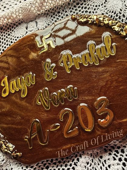 A closer look at the details of the wooden-finish resin nameplate. The Swastik symbol adds an auspicious touch to this handcrafted piece.