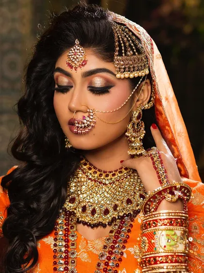 A classic North Indian bridal portrait. We focus on creating a flawless, radiant base and highlighting the eyes, complemented by traditional jewelry to complete the regal look.