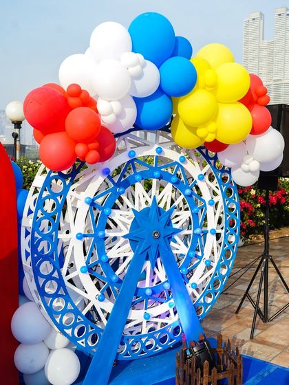 A detailed shot of the decorative blue and white ferris wheel, a key element of the circus theme.