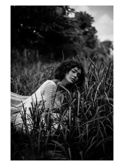 Black and white photography strips away everything but emotion and form. This shot is about texture, mood, and the quiet story told by the model's expression as she interacts with the natural surroundings. It’s a perfect example of a powerful, minimalist portrait.