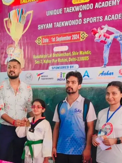 A green belt student with her medal at the Vijay Cup. Every student gets a chance to compete.