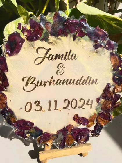 The preserved rose petal plaque displayed on a small easel. It's a wonderful way to display a memory from a special day.