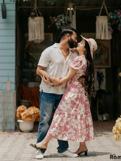 A vibrant and playful shot of a couple about to kiss, set against a colorful, bohemian-style backdrop. This image is full of life, joy, and personality.