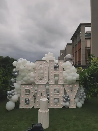 An "OH BABY" marquee letter setup for a daytime outdoor baby shower, creating a bold and celebratory focal point on the lawn.