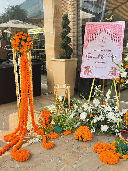 The welcome signage and entrance decor, using vibrant marigold flowers to create a festive and traditional Indian welcome.