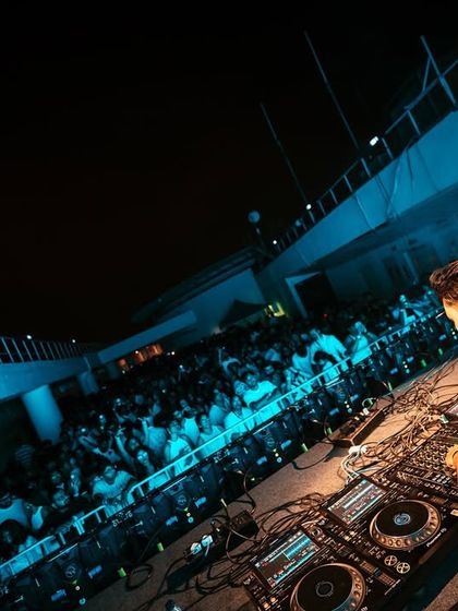 A DJ's perspective of the packed dance floor at the White Party. I design the DJ booth and lighting to make the artist a focal point while connecting them with the crowd's energy.