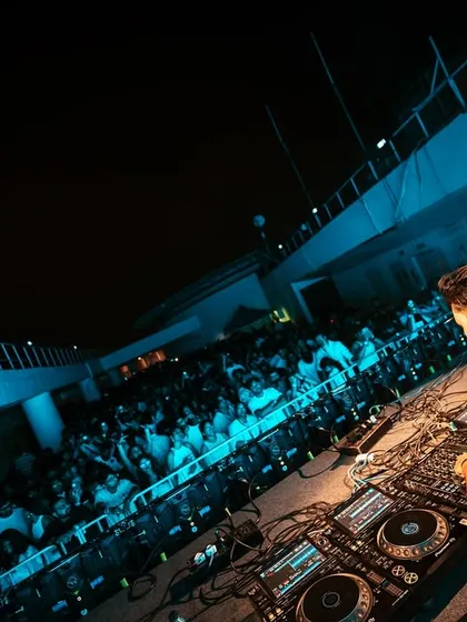 A DJ's perspective of the packed dance floor at the White Party. Our DJs are positioned to have a direct connection with the energetic crowd in front of them.