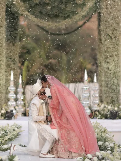 A sweet kiss on the forehead seals their promise. This intimate moment, captured amidst a shower of petals, is a testament to the love story I help to celebrate.