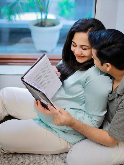 A cozy at-home session, capturing the couple reading together. These lifestyle shots tell a beautiful story about your life as you prepare for the baby.