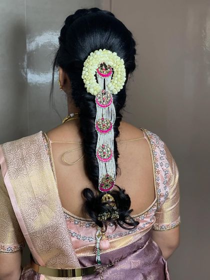A lovely hairstyle for Swathi for her brother's engagement. This braid is decorated with modern, elegant accessories that match her outfit perfectly.