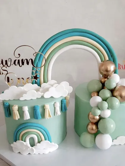 A lovely set of pastel green twin cakes for Divam's first birthday. The boho rainbow theme with tassels and a balloon garland created a cohesive and stylish look for the celebration. The flavors were rich chocolate and vanilla with mixed berries.