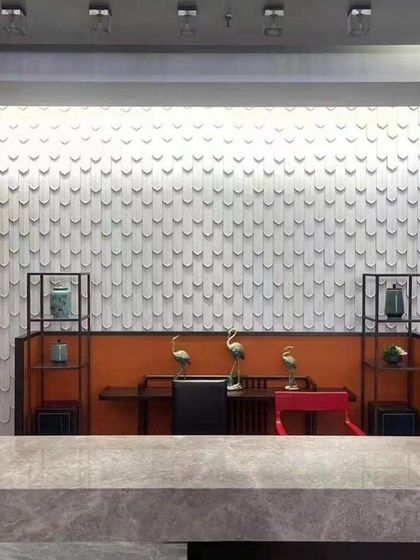 Another view of the feather-patterned wall, installed in a reception or waiting area. It creates a high-end, bespoke look.