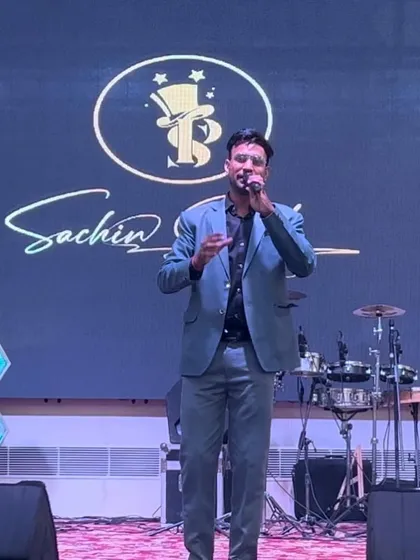 On stage with my logo prominently displayed. A professional stage presence is crucial for any large-scale show.